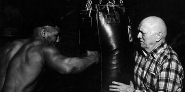 Boxing legend Mike Tyson Cus D'Amato in training.