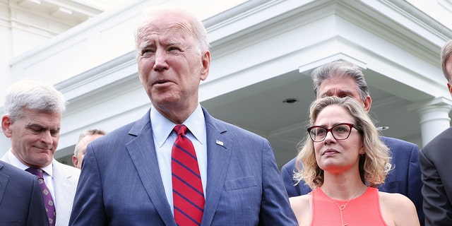 President Biden with Sen. Kyrsten Sinema, D-Ariz., after a bipartisan group of senators reached a deal on an infrastructure package at the White House June 24, 2021, in Washington.
