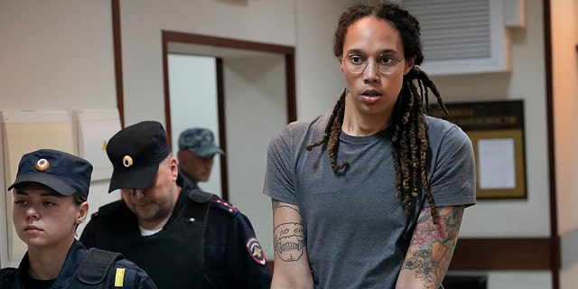 Brittney Griner is escorted from a courtroom after a hearing in Khimki, just outside Moscow, Russia, Aug. 4, 2022.