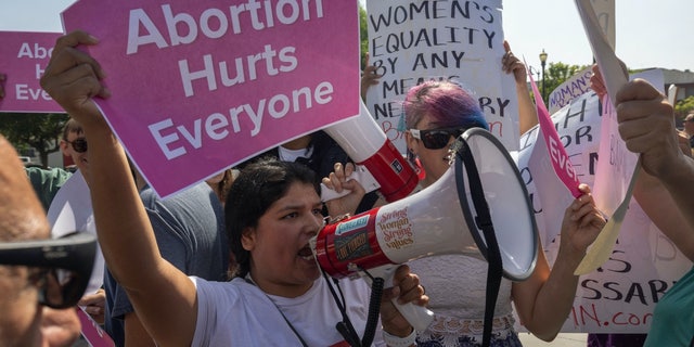 A group of pro-life protesters crashes the Women's March Action Rally for Reproductive Rights at Mariachi Plaza in Los Angeles Oct. 8, 2022.