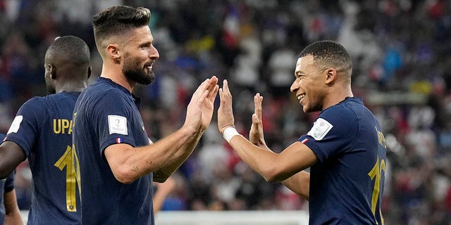 France's Olivier Giroud, left, and France's Kylian Mbappe celebrate after scoring their side's second goal during the World Cup Round of 16 match between France and Poland at Al Thumama Stadium in Doha, Qatar, Sunday, Dec. 4, 2022.