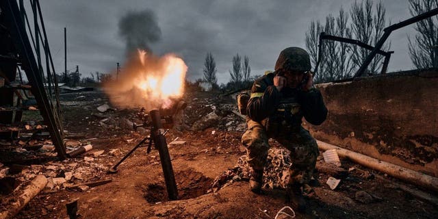 A Ukrainian soldier fires a mortar at Russian positions in Bakhmut, Donetsk region, Ukraine, Thursday, Nov. 10, 2022.