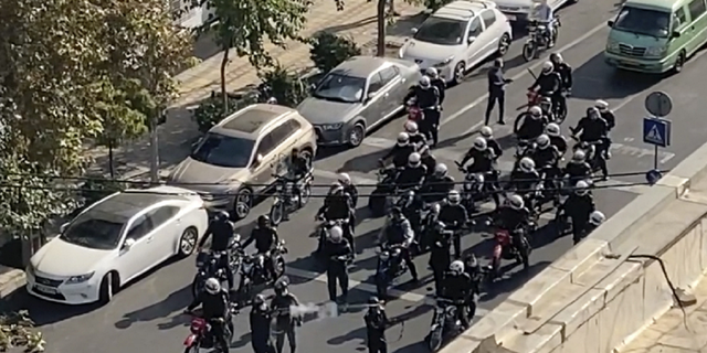 FILE - Iranian police arrive to disperse a protest to mark 40 days since the death in custody of 22-year-old Mahsa Amini, whose tragedy sparked Iran's biggest antigovernment movement in more than a decade.