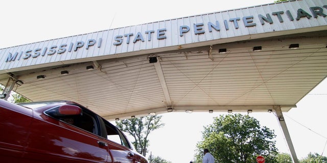 Employees leave the front gate of the Mississippi State Penitentiary in Parchman, Miss. Gov. Tate Reeves on Monday said he will take steps to close part of the prison after a series of deaths and unsanitary living conditions.