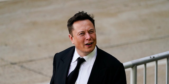 Elon Musk walks from the justice center in Wilmington, Delaware, Monday, July 12, 2021.