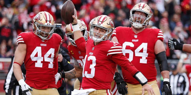 San Francisco 49ers quarterback Brock Purdy (13) celebrates with teammates after running for a touchdown against the Tampa Bay Buccaneers during the first half in Santa Clara, California, Sunday, Dec. 11, 2022.