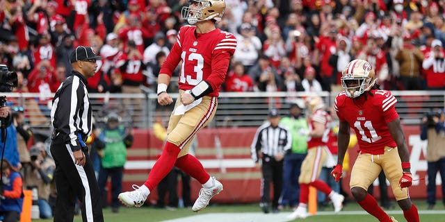 San Francisco 49ers quarterback Brock Purdy (13) celebrates after running for a touchdown against the Tampa Bay Buccaneers during the first half in Santa Clara, California, Sunday, Dec. 11, 2022.