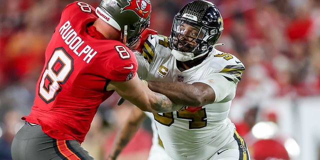 Kyle Rudolph, #8 of the Tampa Bay Buccaneers, blocks Cameron Jordan, #94 of the New Orleans Saints, at Raymond James Stadium on Dec. 5, 2022 in Tampa, Florida.