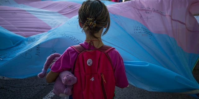 A girl holds the Transgender Pride flag during the pride march held on Sept. 7, 2022, in Madrid, Spain.
