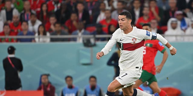 Portugal's forward #07 Cristiano Ronaldo controls the ball during the Qatar 2022 World Cup quarter-final football match between Morocco and Portugal at the Al-Thumama Stadium in Doha on December 10, 2022. 
