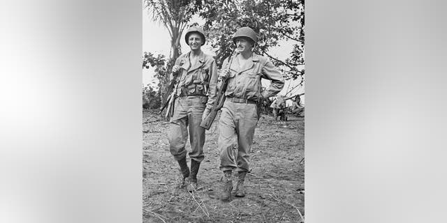 Archibald Roosevelt, left, son of Theodore Roosevelt and a veteran of World War I, and Carl E. Webber of Seattle, Washington, saunter along in New Guinea in World War II.