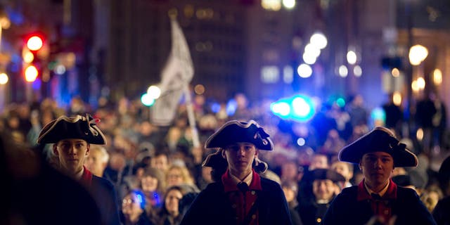 Noah Clewley, center, 15, of West Newbury, plays the snare drum as he marches with the William Diamond Junior Fife and Drum Corps during a Tea Party procession to the harbor from the Old South Meeting House in Boston on Dec. 16, 2015. Reenactors with Boston's Old South Meeting House celebrated the 242nd anniversary of the Boston Tea Party.