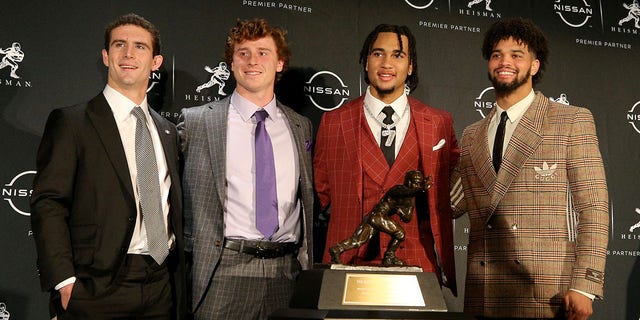 Dec 10, 2022; New York, NY, USA; Heisman finalists (left to right) Georgia quarterback Stetson Bennett and TCU quarterback Max Duggan and Ohio State quarterback C.J. Stroud and Southern California quarterback Caleb Williams pose for a photo with the trophy during a press conference in the Astor Ballroom at the New York Marriott Marquis in New York, NY, before the 2022 Heisman Trophy award ceremony.
