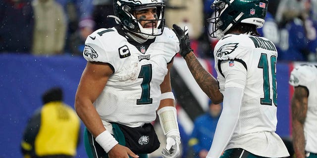Philadelphia Eagles quarterback Jalen Hurts is congratulated by wide receiver Quez Watkins after scoring a touchdown against the New York Giants, Sunday, Dec. 11, 2022, in East Rutherford, New Jersey.
