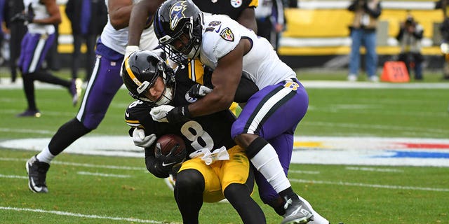 Pittsburgh Steelers quarterback Kenny Pickett (8) is tackled by Baltimore Ravens linebacker Roquan Smith (18) during the first half of an NFL football game in Pittsburgh, Sunday, Dec. 11, 2022. 