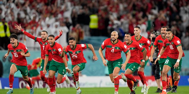 Morocco's players celebrate after the penalty shootout at the World Cup Round of 16 match between Morocco and Spain at Education City Stadium in Al Rayyan, Qatar, Tuesday, Dec. 6, 2022.