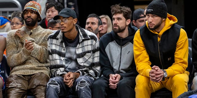 Brooklyn Nets players who did not dress for an NBA basketball game against the Indiana Pacers watch the action on the court during the second half in Indianapolis, Saturday, Dec. 10, 2022. From left to right, Kyrie Irving, Nic Claxton, Joe Harris and Ben Simmons.