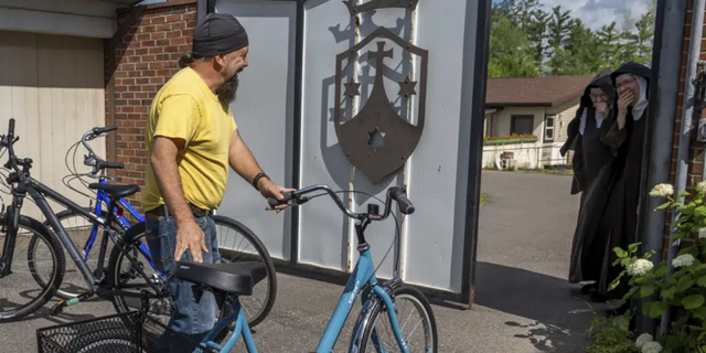 Steven Pringle delivers three bikes as donations to surprised nuns at the Carmelite Monastery of the Holy Cross in Iron Mountain, Mich., on Friday, July 29, 2022. 