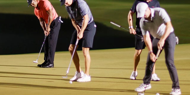 Tiger Woods of the United States putts under the feet of Jordan Spieth of the United States during The Match 7 at Pelican at Pelican Golf Club on December 10, 2022 in Belleair, Florida.