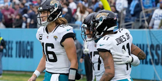 Jacksonville Jaguars tight end Evan Engram (17) is congratulated by teammates Trevor Lawrence (16) and Marvin Jones Jr. after scoring during the first half against the Tennessee Titans, Sunday, Dec. 11, 2022, in Nashville, Tennessee.