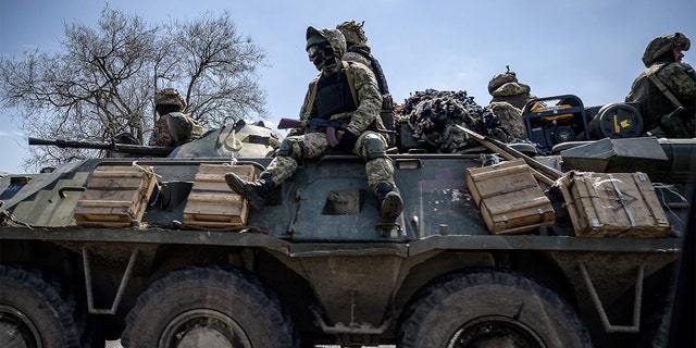 Ukrainian servicemen ride on an armored personnel carrier as they make their way along a highway on the outskirts of Kryvyi Rih on April 28, 2022, amid Russia's military invasion launched on Ukraine. (Photo by ED JONES/AFP via Getty Images)