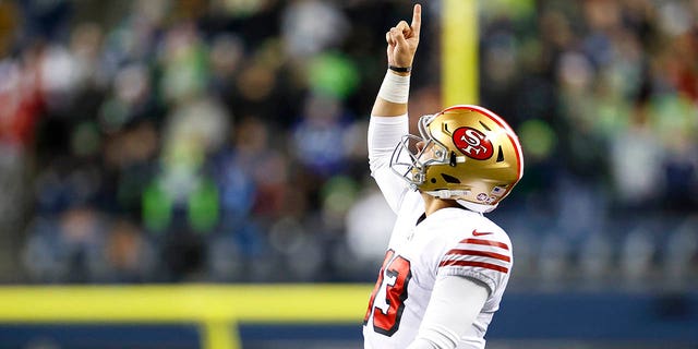 Brock Purdy #13 of the San Francisco 49ers celebrates after a touchdown against the Seattle Seahawks during the third quarter of the game at Lumen Field on December 15, 2022 in Seattle, Washington. 