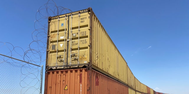 Construction to place these shipping containers in gaps in the border wall began in Yuma, Arizona. Republican Gov. Doug Ducey of Arizona is suing the federal government over an order to remove shipping containers used to fill gaps at the southern border.